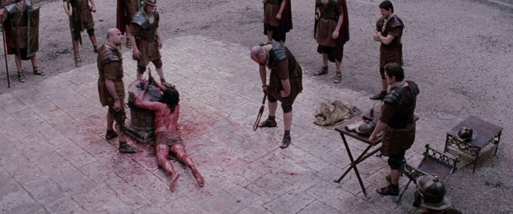 flagelacion-de-jesus-pelicula-la-pasion-de-cristo Jesús es brutalmente flagelado por soldados romanos, escena representada en la película La Pasión de Cristo.